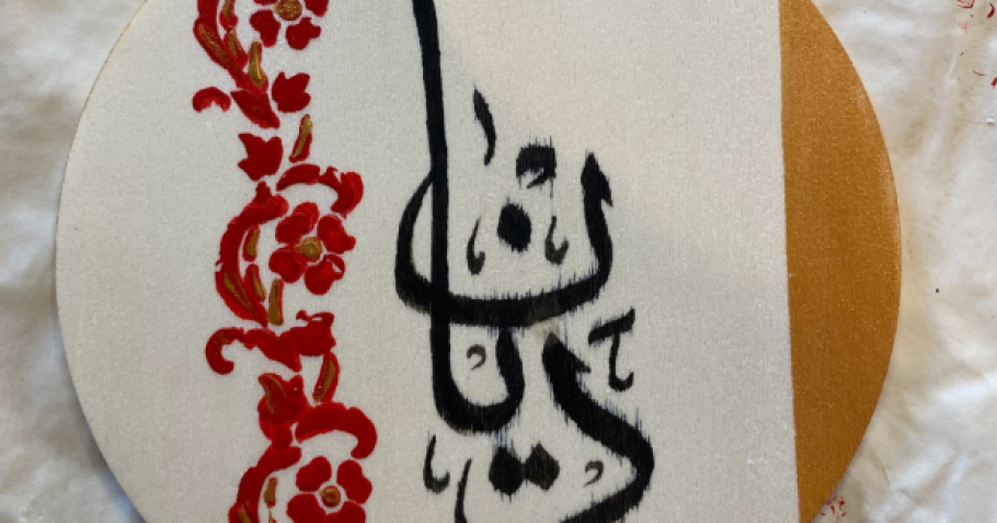 A wooden disc featuring Arabic calligraphy.