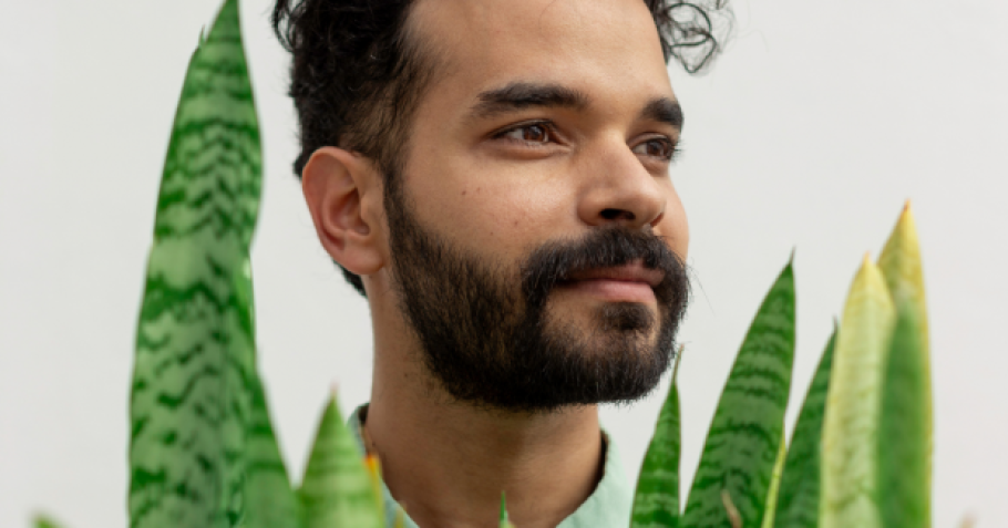 Mauricio Chades behind a plant.