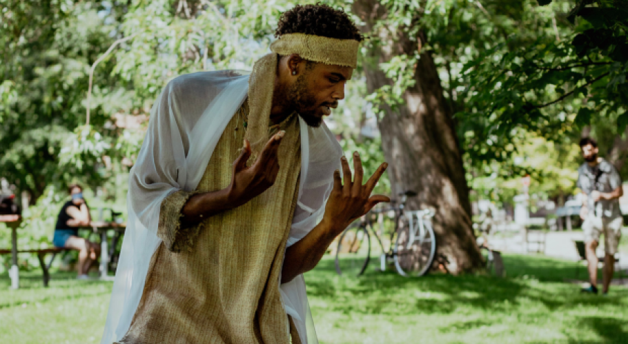 A person wearing a yellow headband and yellow shirt bent over with their hands gesturing expressively.