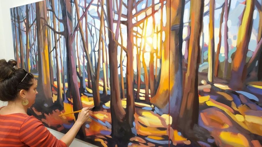 Michelle Reid painting a forest scene. 
