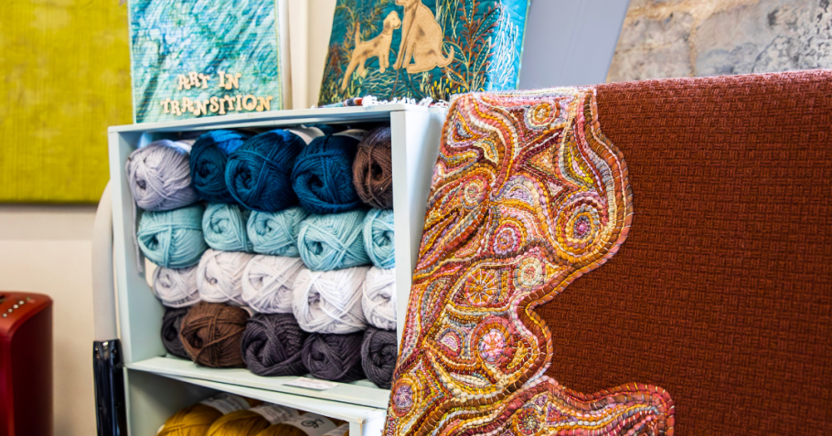 Bethany Garner's studio, including her artwork and neatly arranged yarn balls.