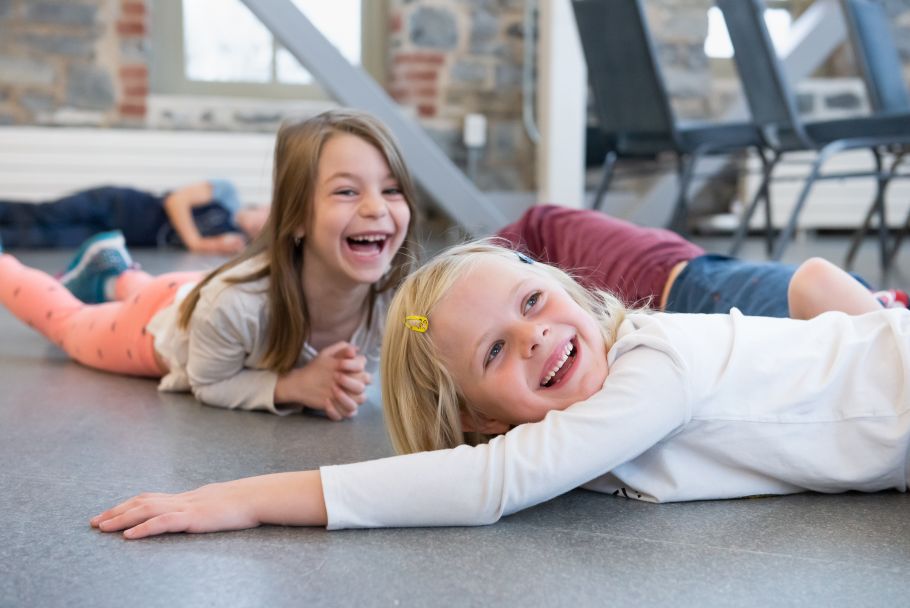 Children lay on the floor laughing