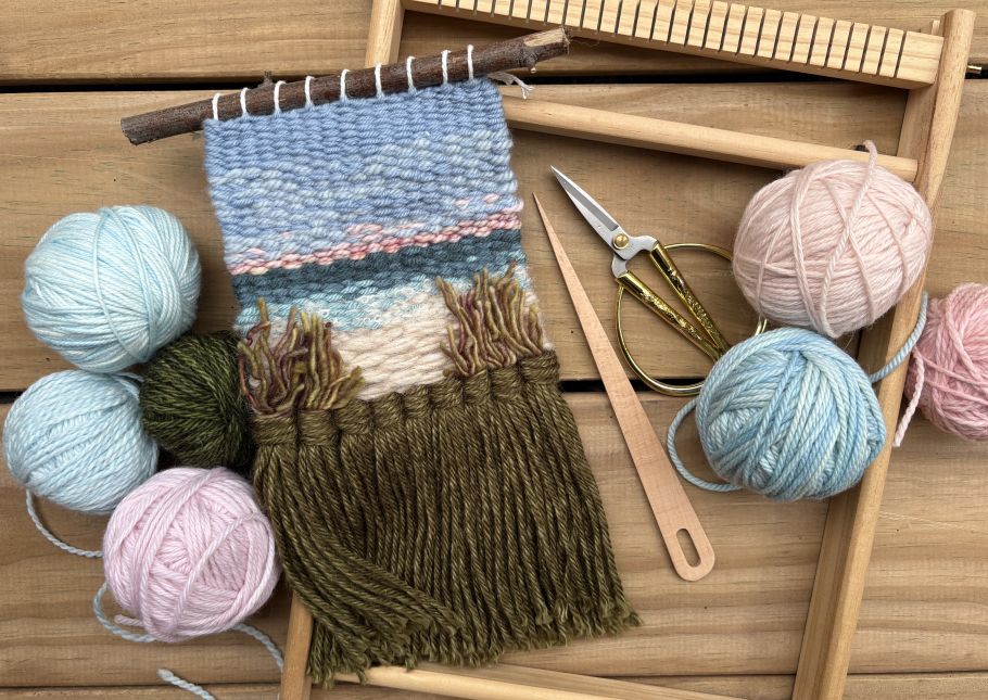 Weaving example of a landscape with yarn next to it