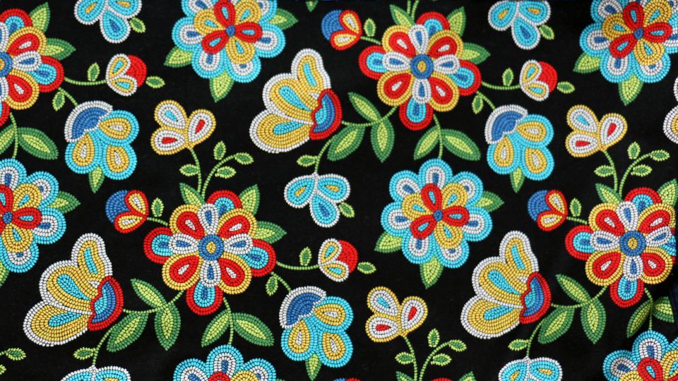 Beaded flowers across a black backdrop