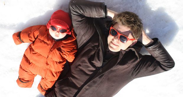 Baby and Man relaxing in the snow